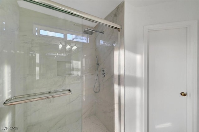 full bathroom with a marble finish shower