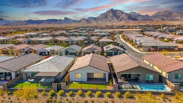 drone / aerial view featuring a residential view and a mountain view