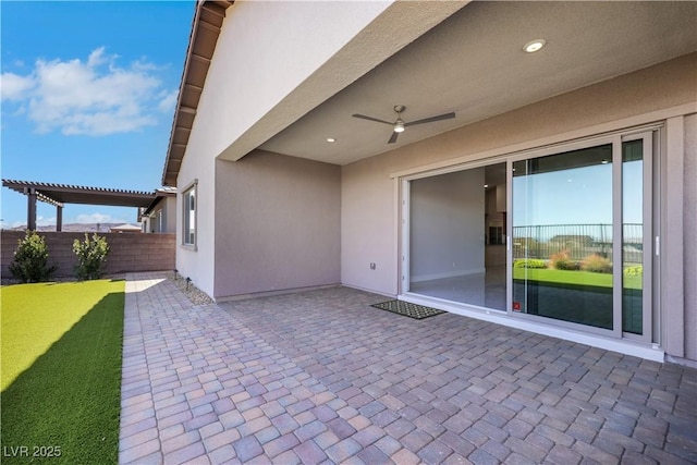 view of patio featuring fence, a ceiling fan, and a pergola