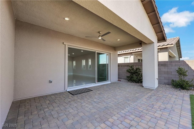 view of patio / terrace featuring fence and a ceiling fan