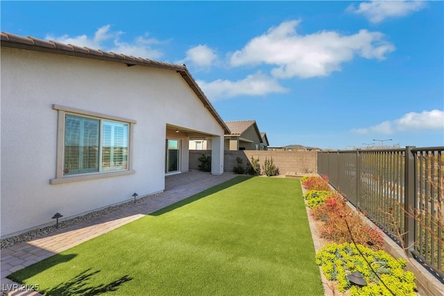 view of yard with a patio area and a fenced backyard