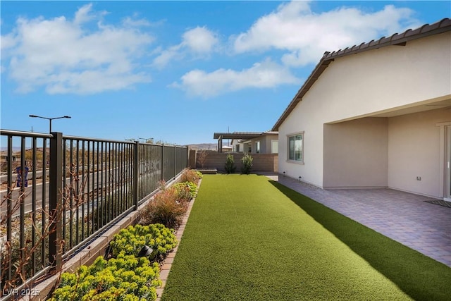 view of yard with a fenced backyard and a patio