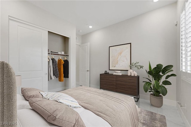 bedroom with marble finish floor, a closet, recessed lighting, and baseboards