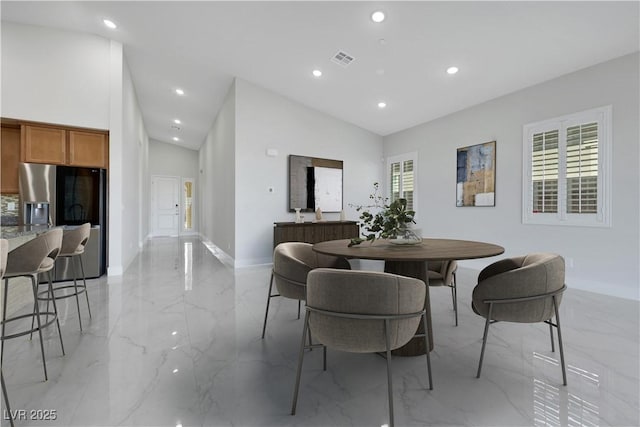 dining space featuring marble finish floor, a wealth of natural light, visible vents, and recessed lighting