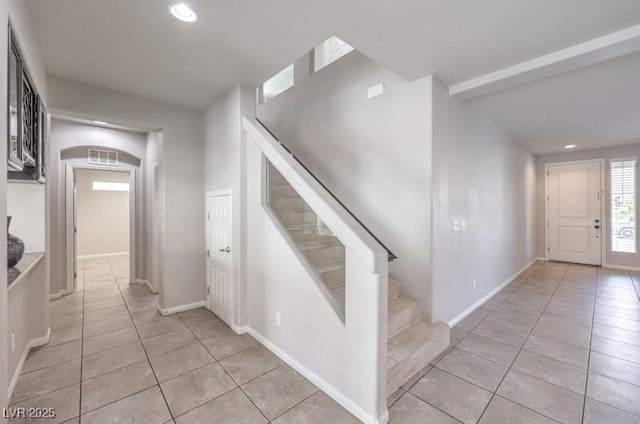 entrance foyer with light tile patterned floors, stairs, and recessed lighting