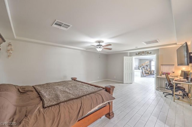 bedroom with ceiling fan, light wood finished floors, visible vents, and baseboards