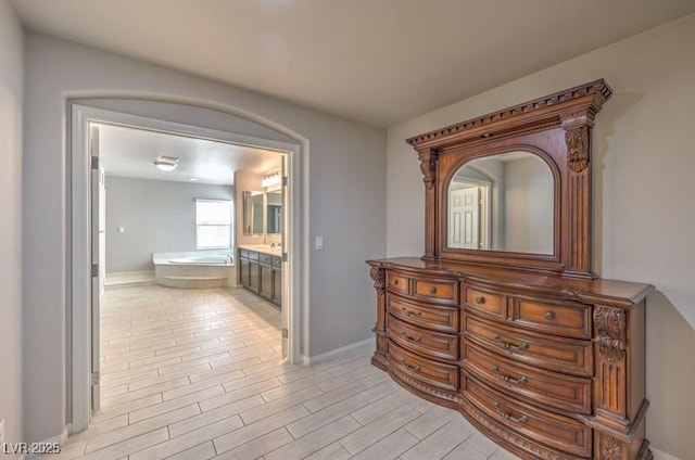 hallway with light wood-style flooring and baseboards