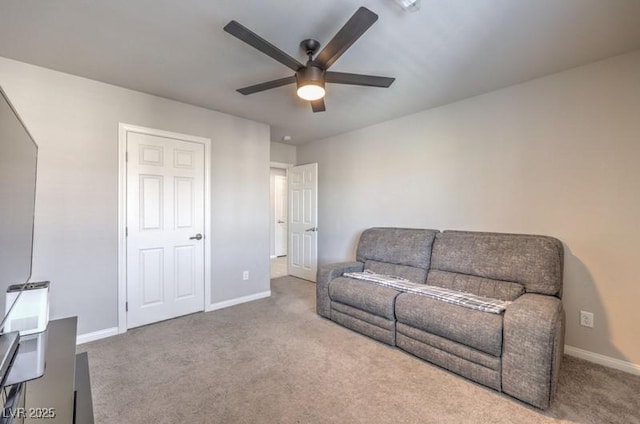 carpeted living room featuring ceiling fan and baseboards