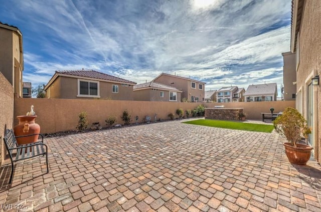 view of patio with a residential view and a fenced backyard