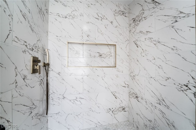 details featuring a marble finish shower