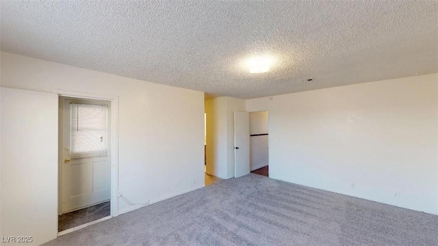 unfurnished bedroom with carpet flooring and a textured ceiling