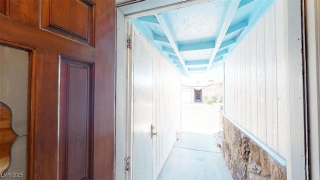 hallway with wood walls