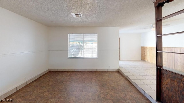 empty room with visible vents and a textured ceiling