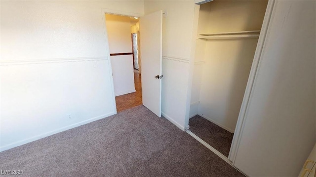 unfurnished bedroom featuring a closet, baseboards, and carpet floors