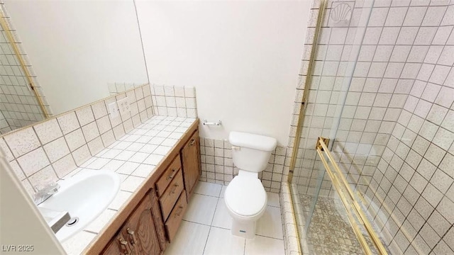 full bathroom featuring tile patterned floors, a shower stall, toilet, and vanity