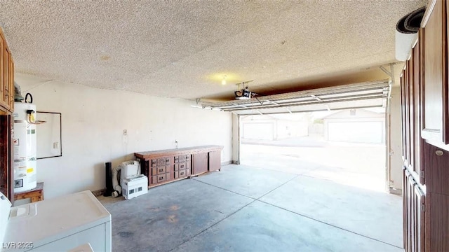 garage with gas water heater, washer / dryer, and a garage door opener