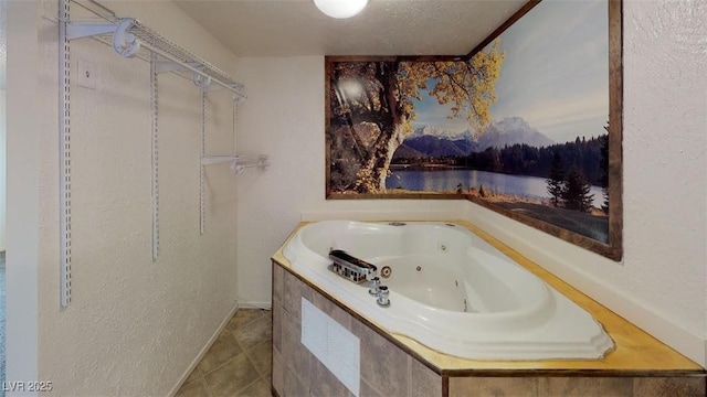 full bathroom with tile patterned flooring, a jetted tub, a textured wall, and a water view