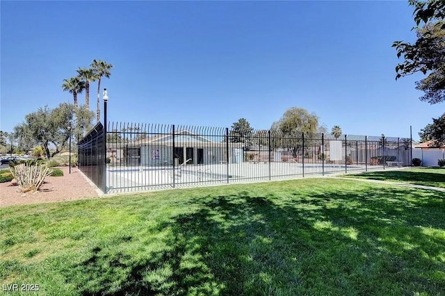 view of community with a lawn and fence