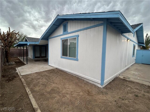 view of side of home with a patio and a fenced backyard