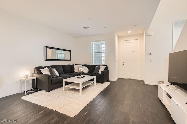 living room with baseboards, visible vents, and dark wood-style flooring