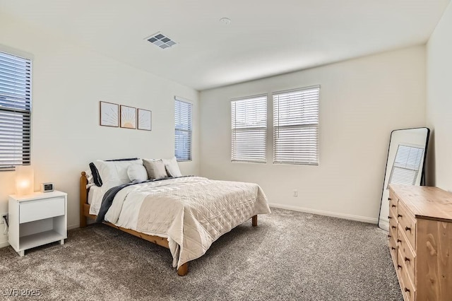 carpeted bedroom with visible vents and baseboards