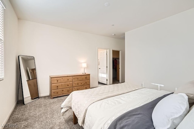 carpeted bedroom featuring baseboards