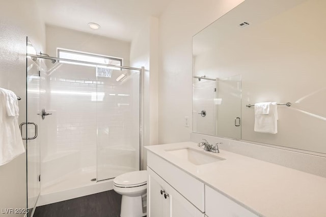 bathroom featuring toilet, a shower stall, visible vents, and vanity