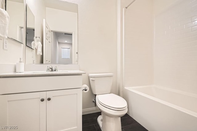 bathroom with baseboards, shower / tub combination, vanity, and toilet