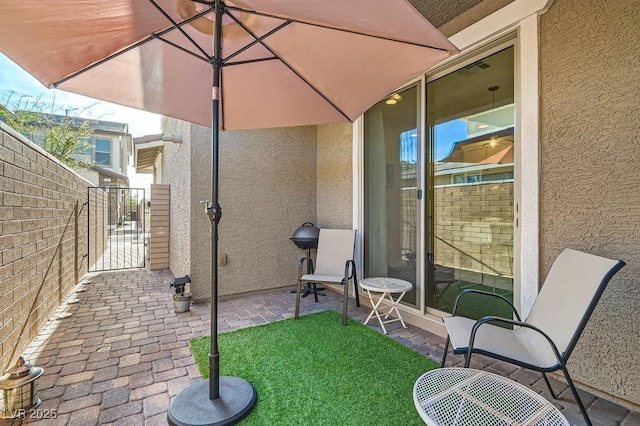 view of patio / terrace featuring a gate and fence