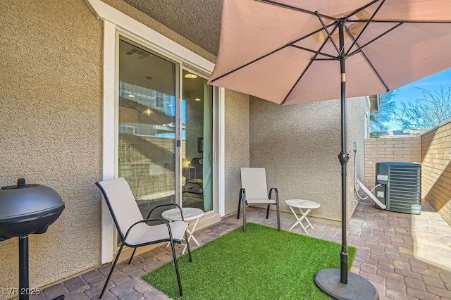 view of patio featuring fence and central air condition unit