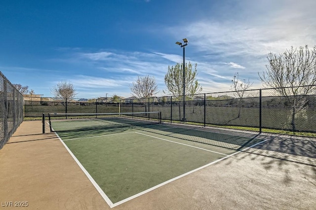 view of sport court featuring fence