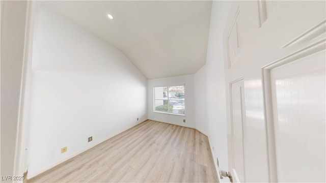 empty room with high vaulted ceiling, recessed lighting, and light wood-style floors