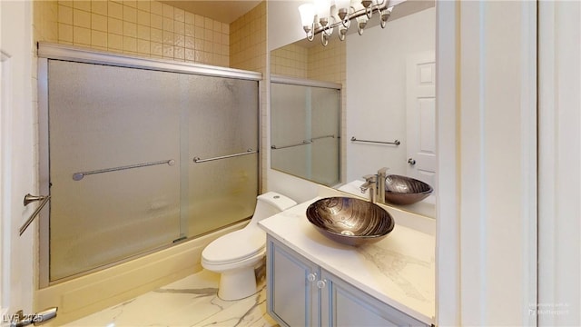 bathroom featuring marble finish floor, vanity, and toilet