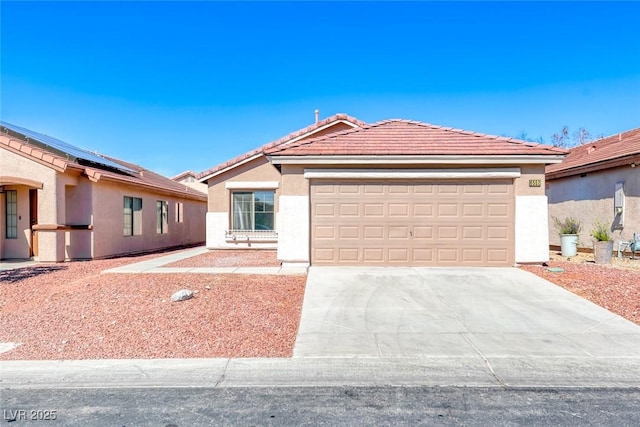 single story home with an attached garage, a tile roof, concrete driveway, and stucco siding