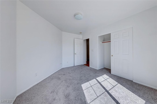 unfurnished bedroom featuring carpet floors, a closet, and baseboards