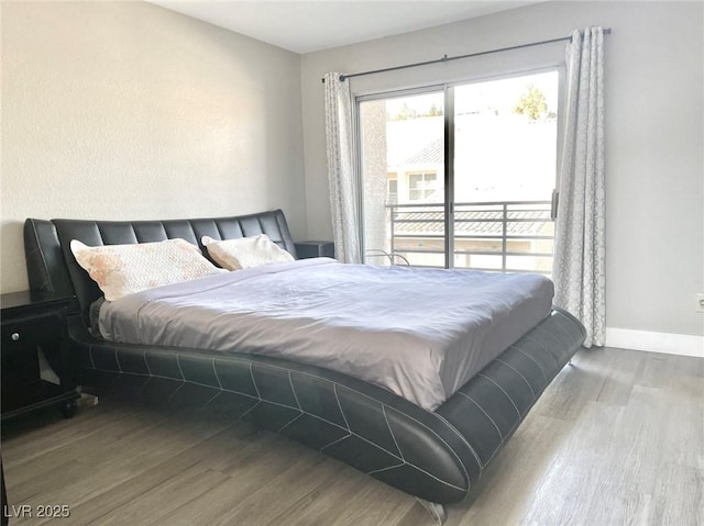 6250 W Flamingo Rd Unit 103, Las Vegas, NV 89103 - bedroom featuring wood finished floors, access to exterior, and baseboards