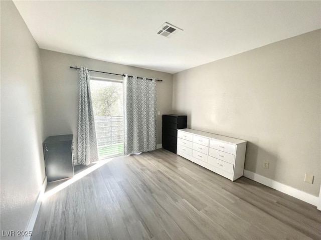 6250 W Flamingo Rd Unit 103, Las Vegas, NV 89103 - unfurnished bedroom with baseboards and light wood-type flooring
