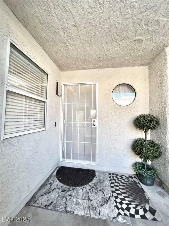 6250 W Flamingo Rd Unit 103, Las Vegas, NV 89103 - doorway to property featuring stucco siding