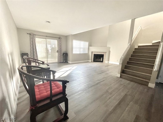 6250 W Flamingo Rd Unit 103, Las Vegas, NV 89103 - living area featuring wood finished floors, baseboards, stairway, and a tiled fireplace