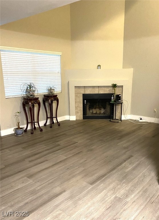 6250 W Flamingo Rd Unit 103, Las Vegas, NV 89103 - living room with lofted ceiling, wood finished floors, a fireplace, and baseboards