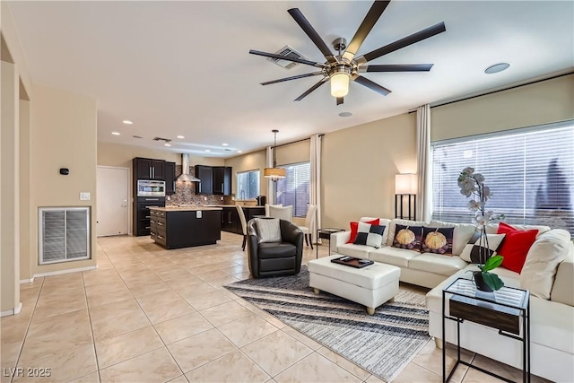 living room featuring recessed lighting, light tile patterned flooring, visible vents, and a ceiling fan