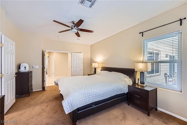 bedroom featuring baseboards, visible vents, a ceiling fan, and light colored carpet