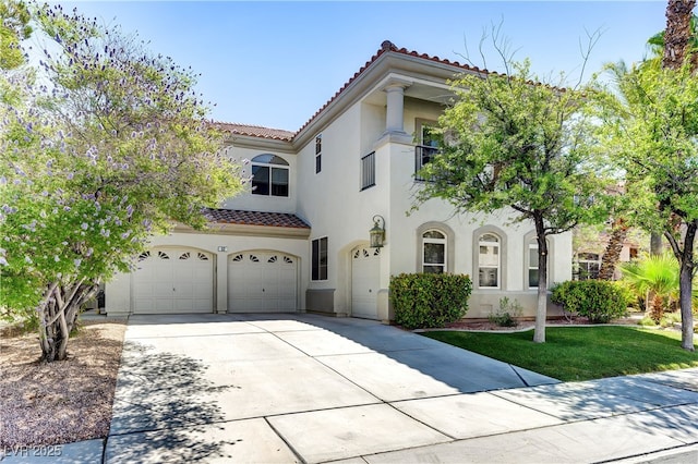 mediterranean / spanish home with a garage, a tiled roof, concrete driveway, and stucco siding