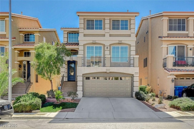 view of front of home featuring a garage, driveway, and stucco siding