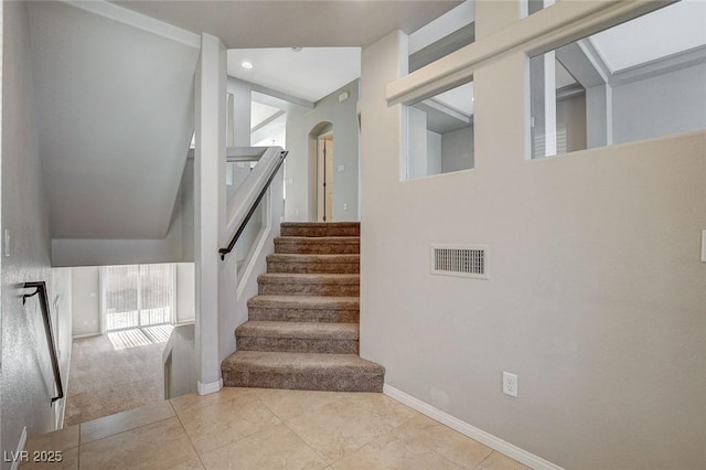 staircase with tile patterned flooring, visible vents, and baseboards