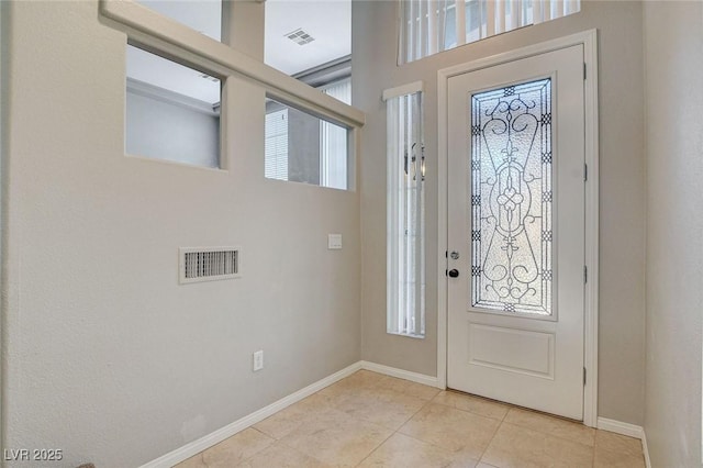 entrance foyer featuring light tile patterned floors, baseboards, and visible vents