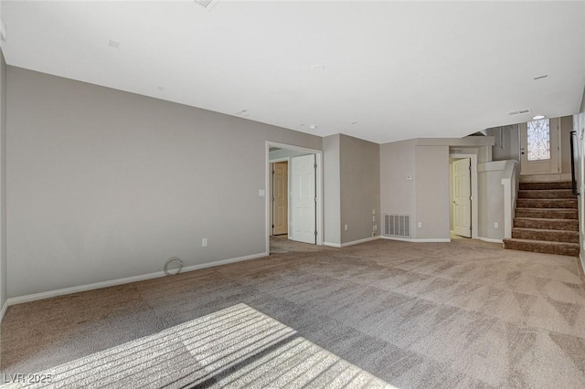 unfurnished living room featuring stairway, carpet flooring, visible vents, and baseboards