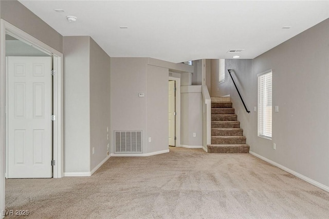 interior space with visible vents, baseboards, and stairs