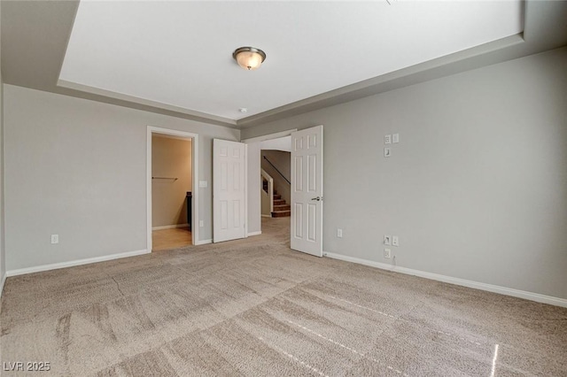 carpeted spare room with baseboards