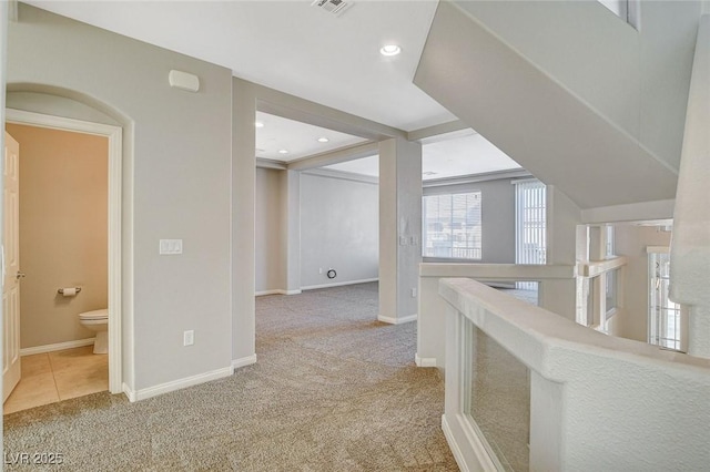 corridor with visible vents, baseboards, carpet, an upstairs landing, and recessed lighting